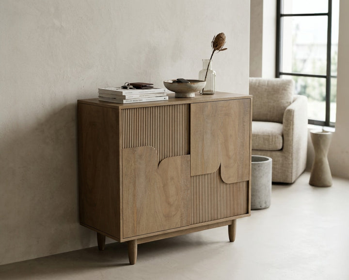 Nakoda Homes Art Deco Ridge Cabinet with fluted wood doors and tapered legs, a stylish storage solution.