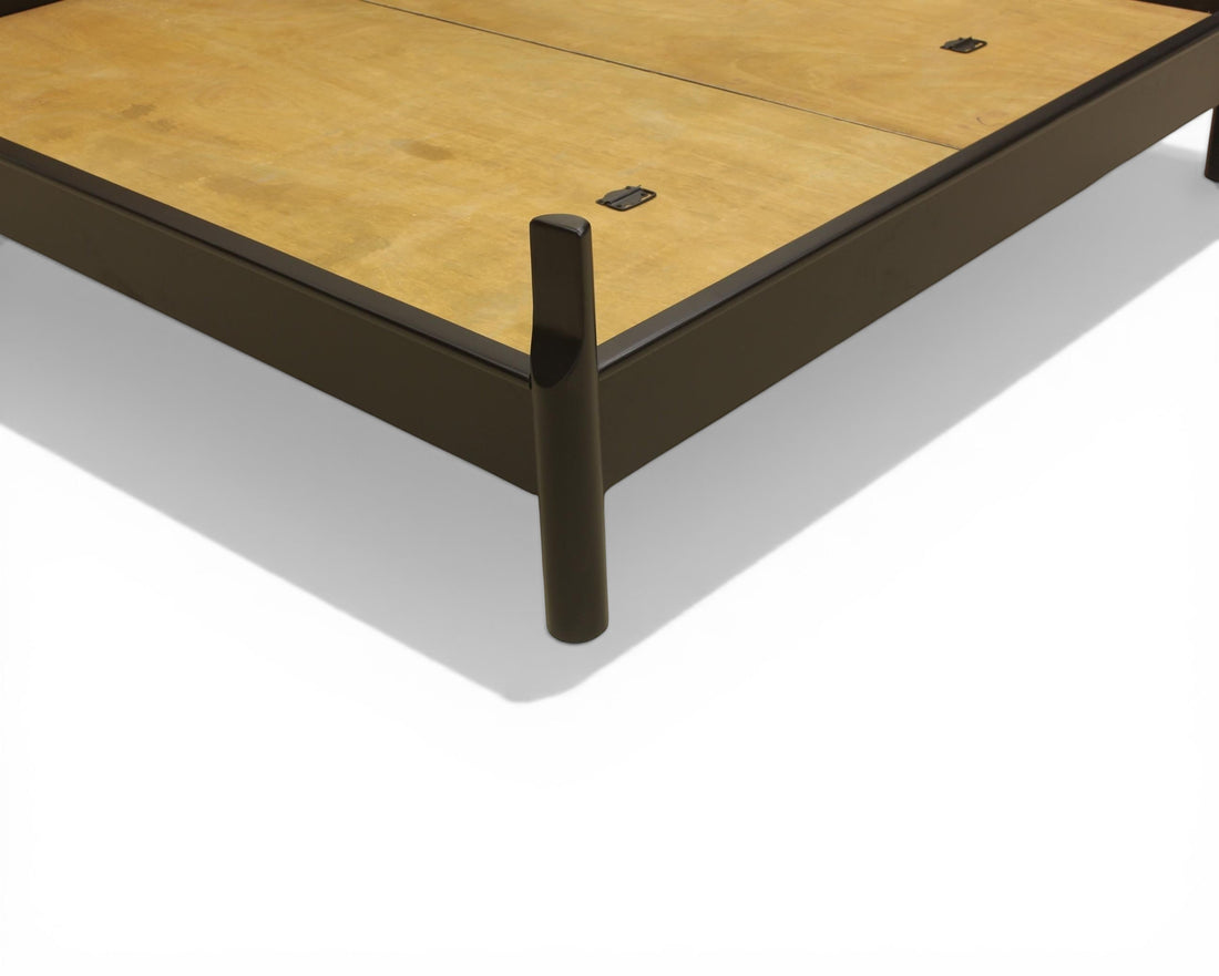 Nakoda Homes modern black metal platform bed frame with wooden slats and tapered legs.