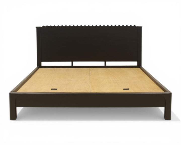Nakoda Homes black wood platform bed frame with scalloped headboard and low profile.