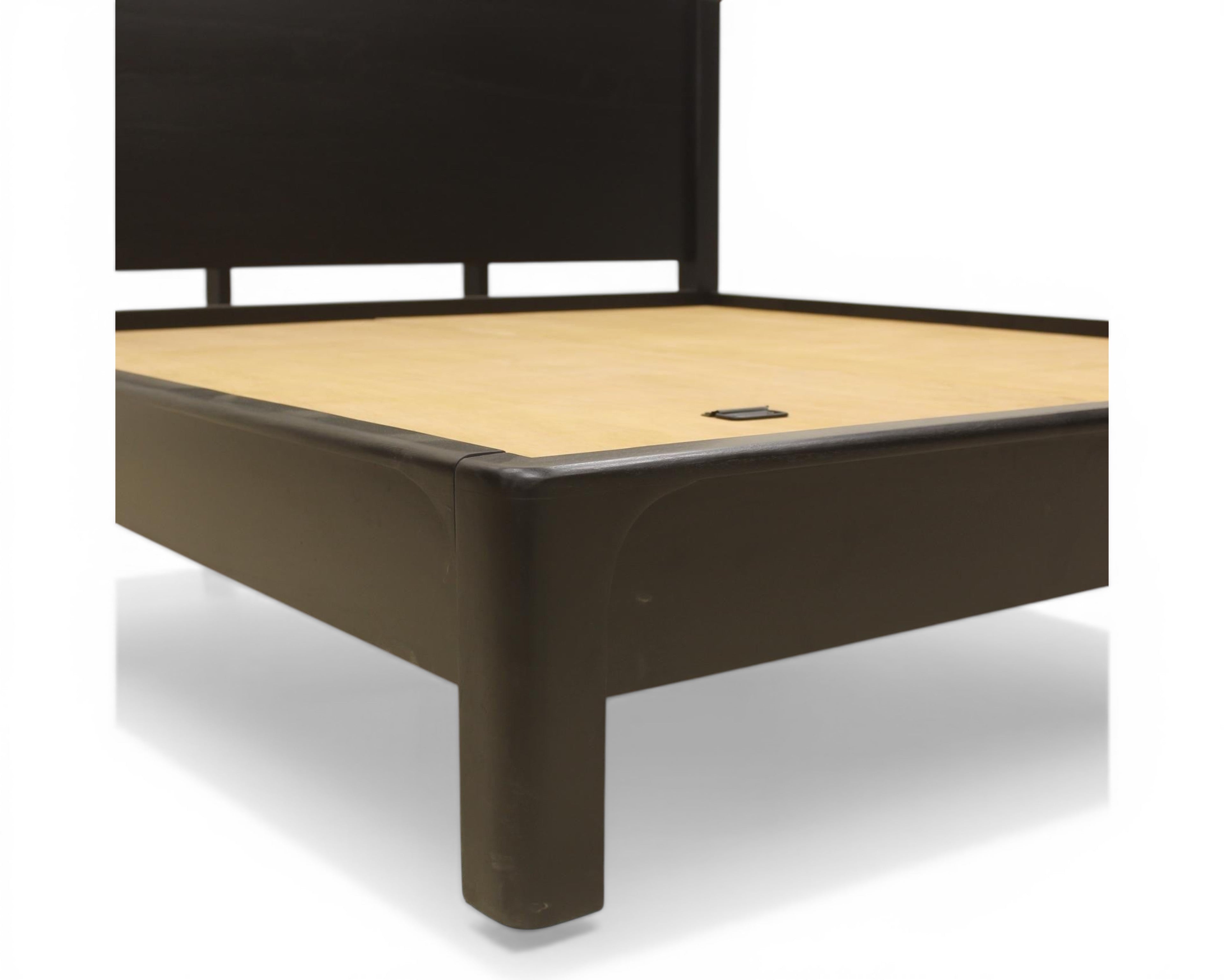 Nakoda Homes black wood modern platform bed frame with scalloped headboard and low-profile design.