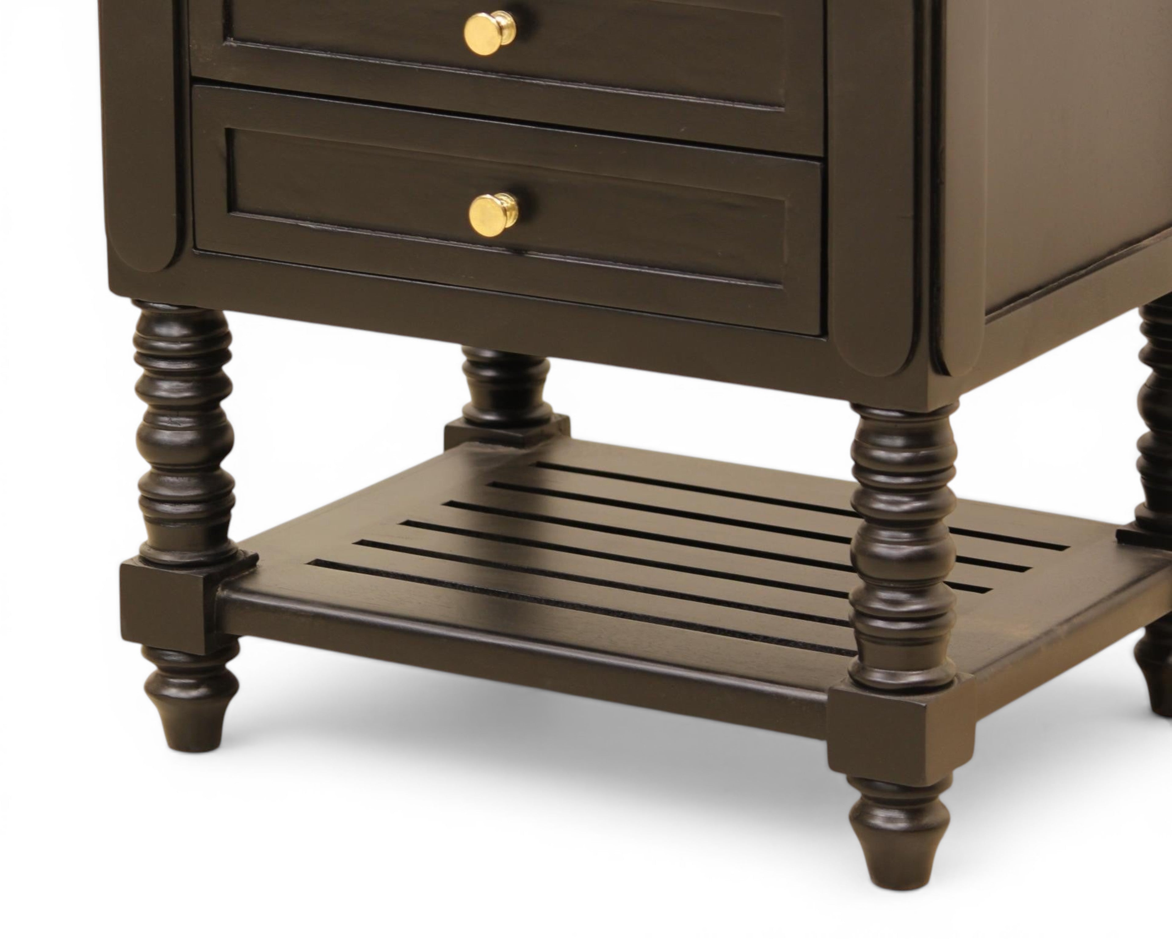 Nakoda Homes black wooden nightstand with two drawers, gold hardware, and slatted shelf. Features turned legs and classic design.