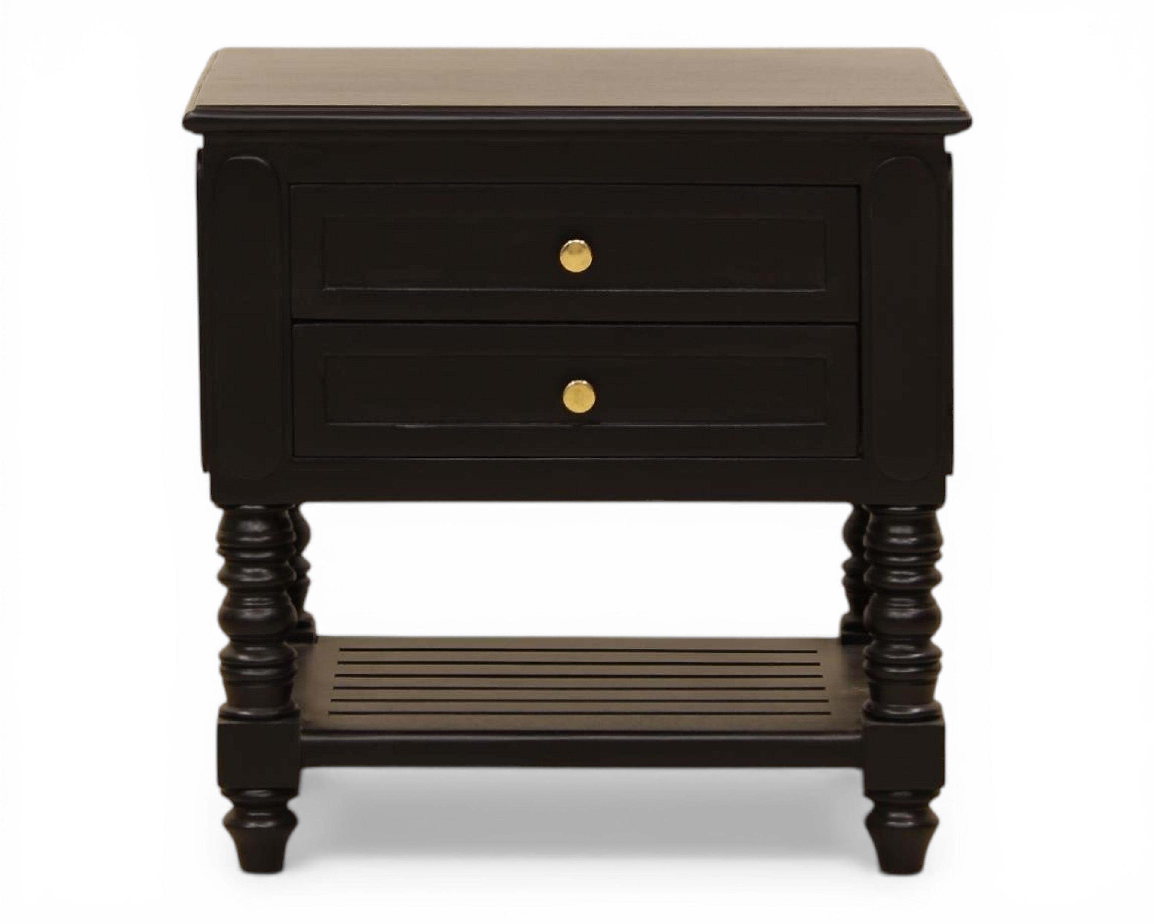 Nakoda Homes black wooden nightstand with two drawers, gold hardware, and slatted shelf. Classic bedside table with turned legs.