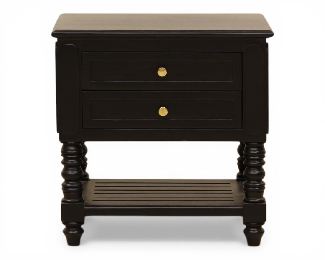 Nakoda Homes black wooden nightstand with two drawers, gold hardware, and slatted shelf. Classic bedside table with turned legs.
