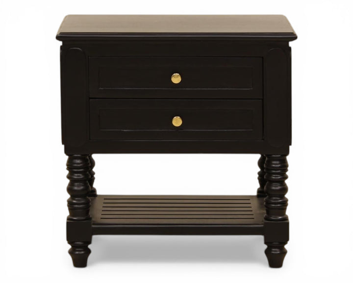 Nakoda Homes black wooden nightstand with two drawers, gold hardware, and slatted shelf. Classic bedside table with turned legs.