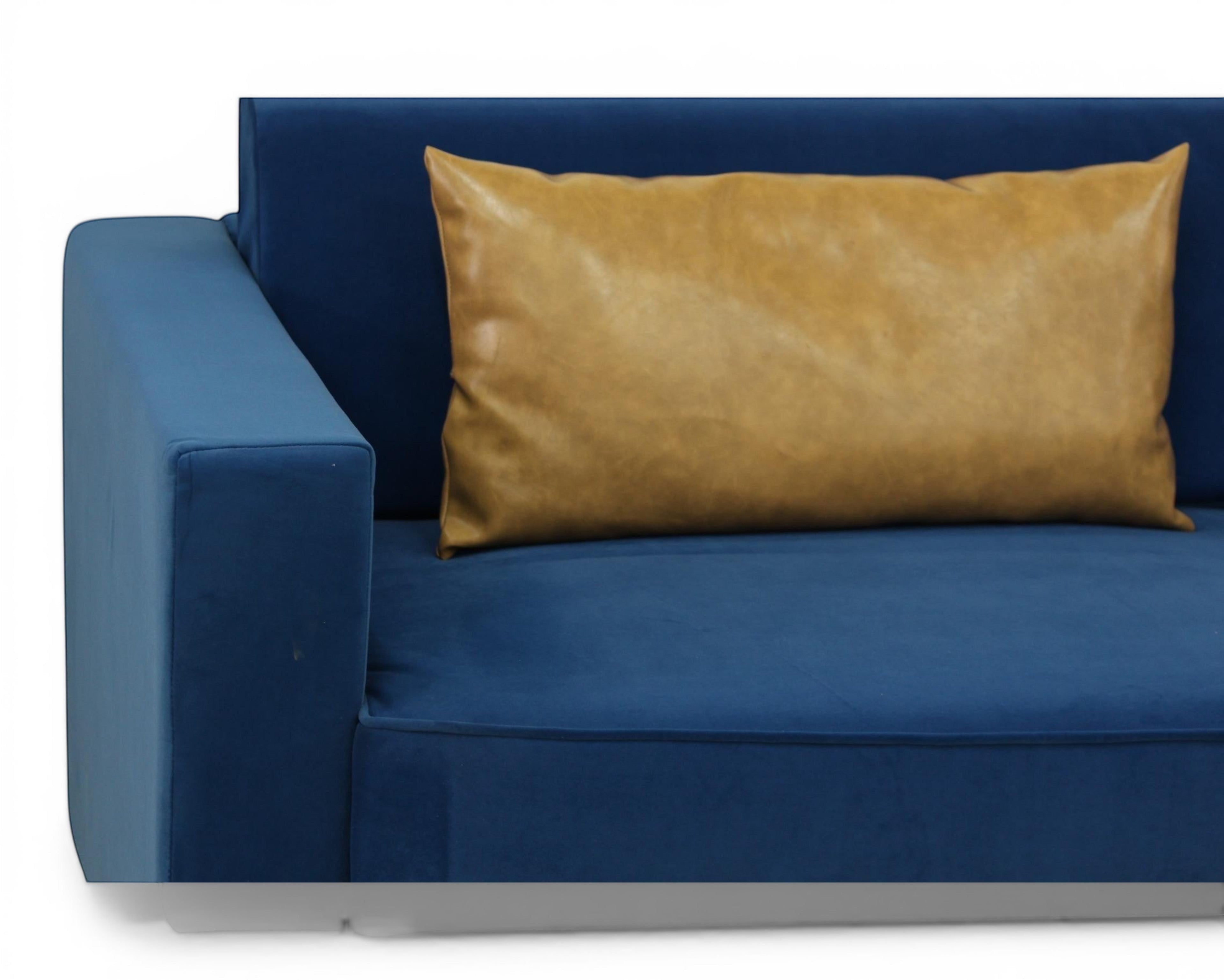 Nakoda Homes blue velvet sofa with tan accent pillow, modern design, plush upholstery.