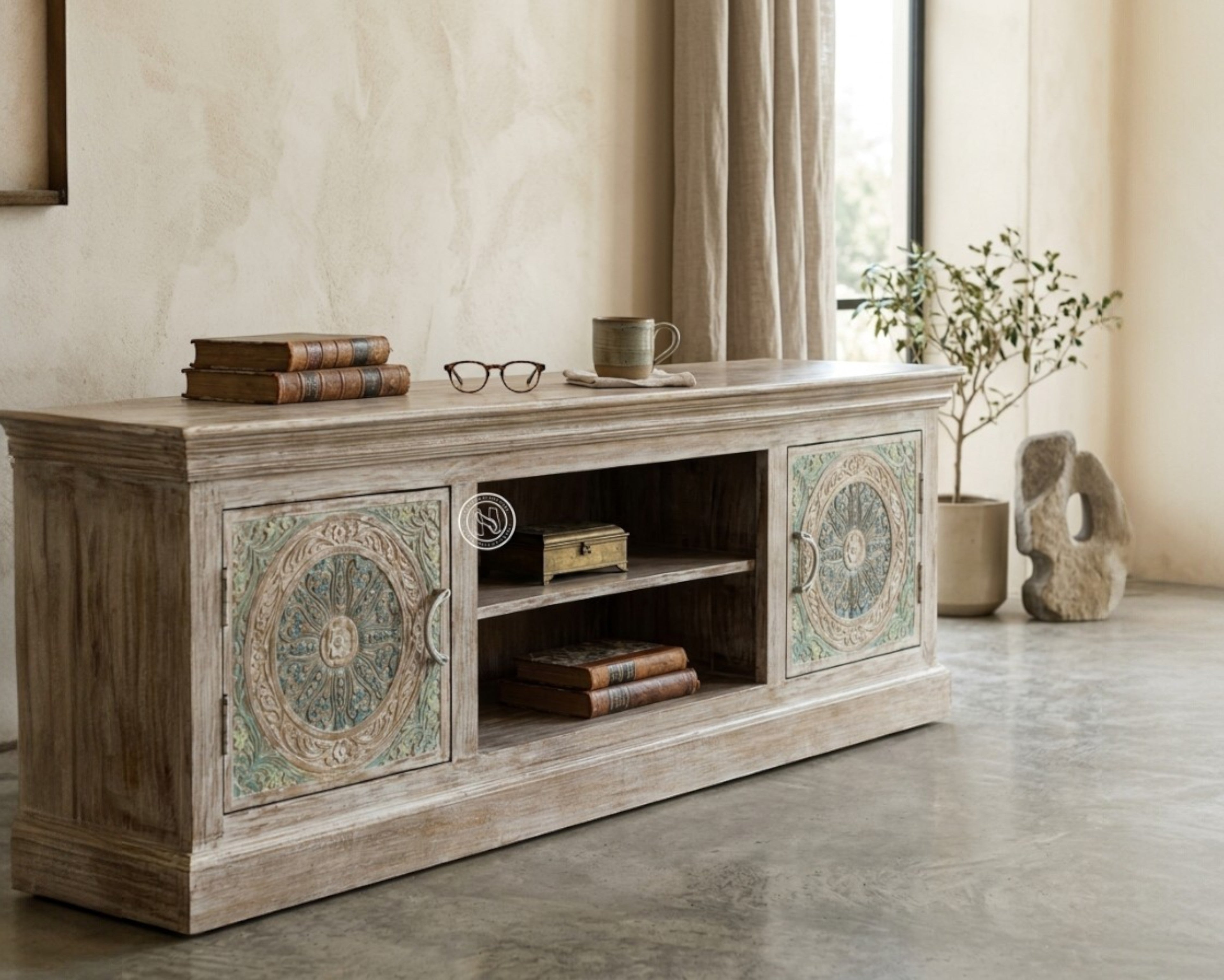 Nakoda Homes Calista TV unit with hand-carved floral and geometric patterns on distressed wood doors.