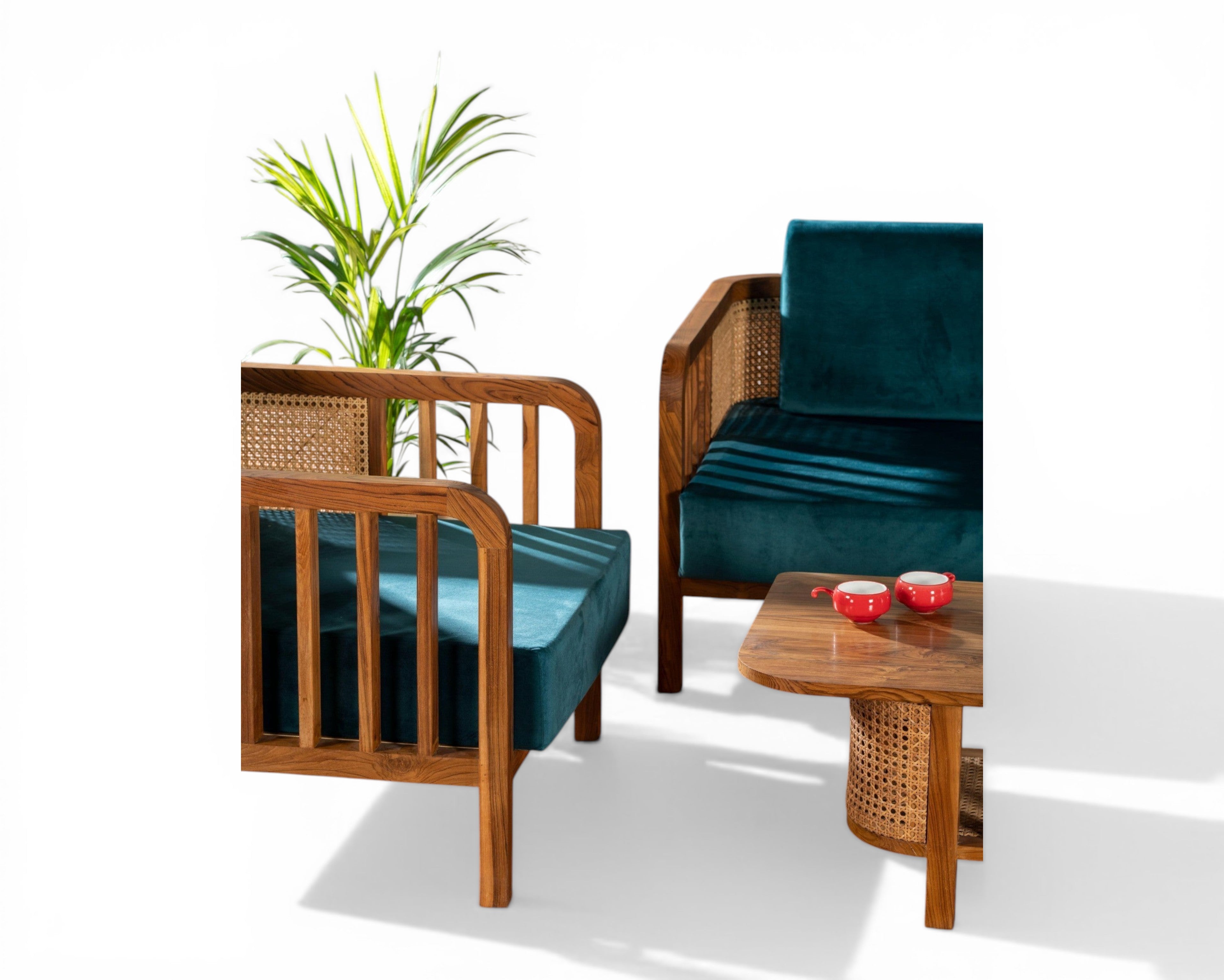 Nakoda Homes wooden armchair and sofa set with cane detailing and deep teal velvet upholstery.