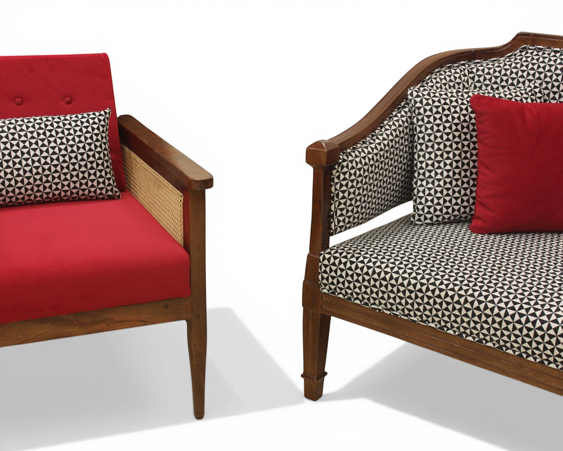 Nakoda Homes red armchair with cane detailing and patterned accent pillow, and a matching sofa with black and white geometric print.