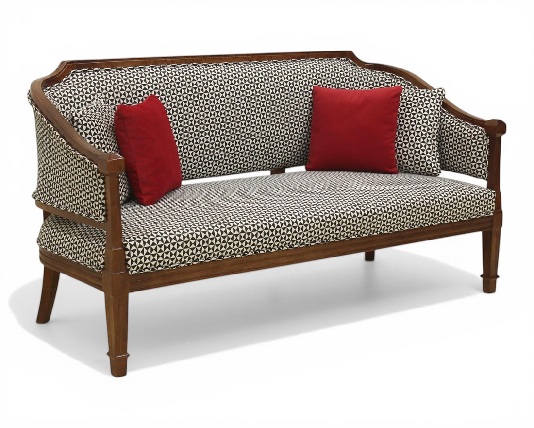 Nakoda Homes classic armchair and sofa set with wooden frame, black and white geometric pattern upholstery, and red accent pillows.