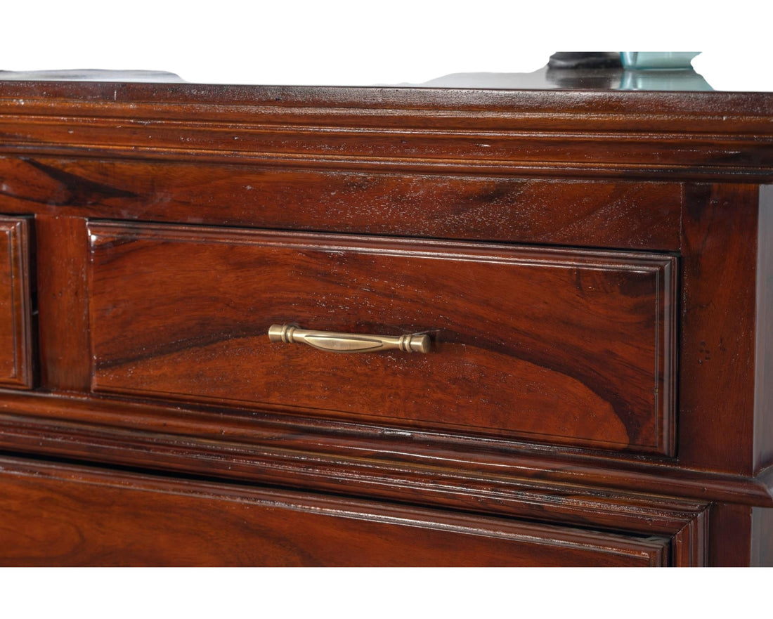 Nakoda Homes classic solid wood chest of drawers in warm brown with brass hardware and polished finish.