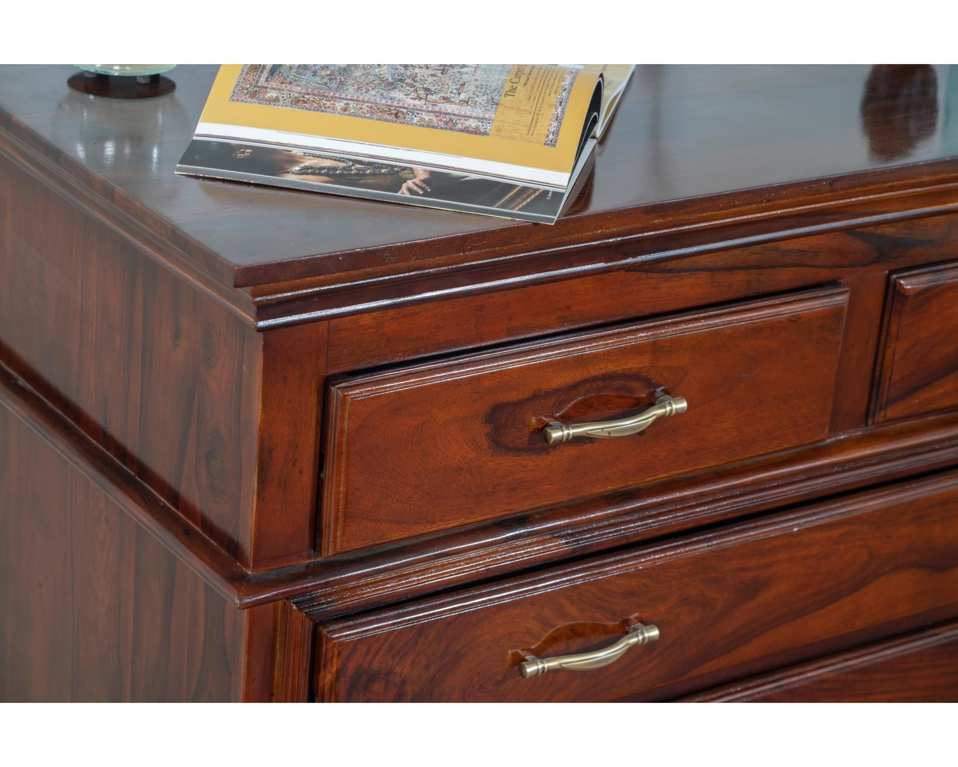 Nakoda Homes classic solid wood chest of drawers in warm brown with brass hardware and polished finish.