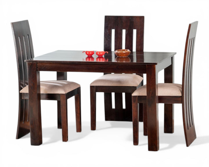 Nakoda Homes dark wood 4-seater dining set with cushioned chairs and modern slatted backs.