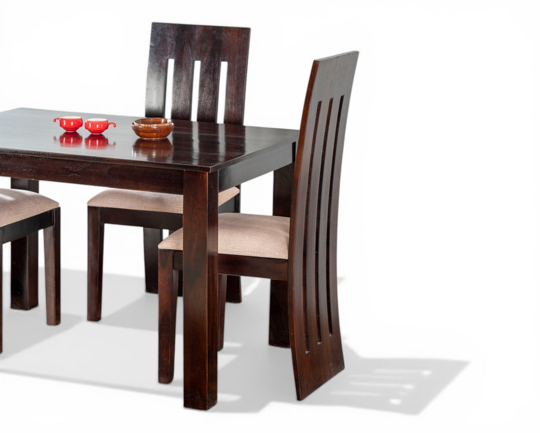 Nakoda Homes dark wood 4-seater dining set with cushioned chairs and modern slatted backs.
