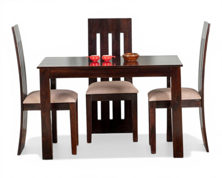 Nakoda Homes dark wood 4-seater dining set with cushioned chairs and a sleek, modern design.