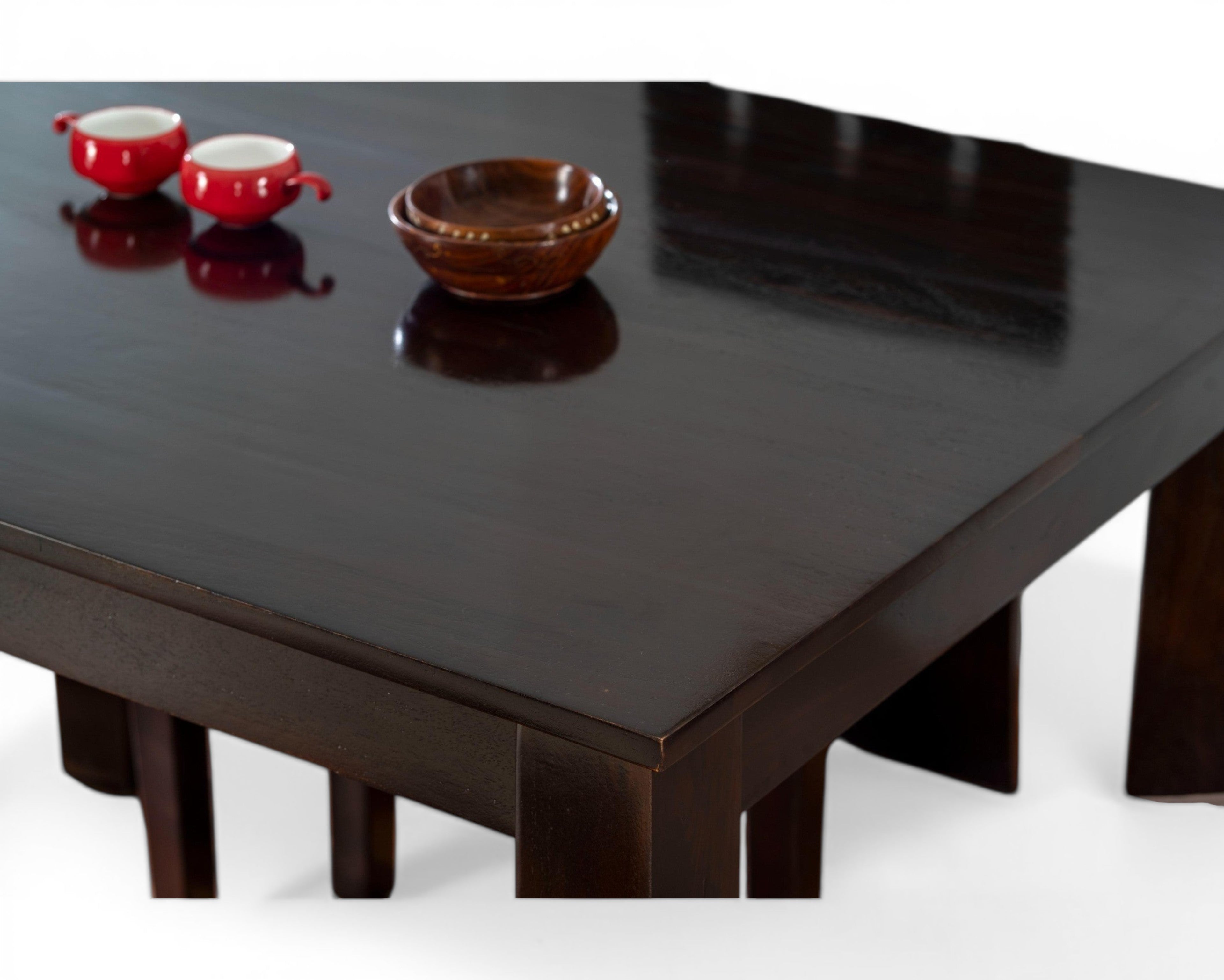 Nakoda Homes dark wood 4-seater dining set with cushioned chairs and a smooth table surface.