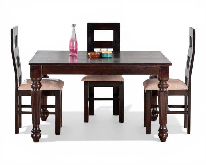 Nakoda Homes dark wood dining set with turned legs. Includes table and four chairs, two with neutral upholstered seats.