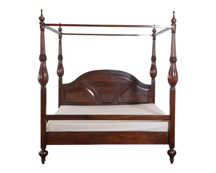 Nakoda Homes traditional dark wood four poster bed frame with arched headboard and turned posts.