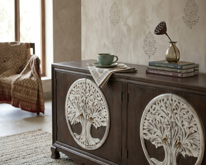 Nakoda Homes dark wood sideboard with white tree of life carvings on double doors and brass knobs.