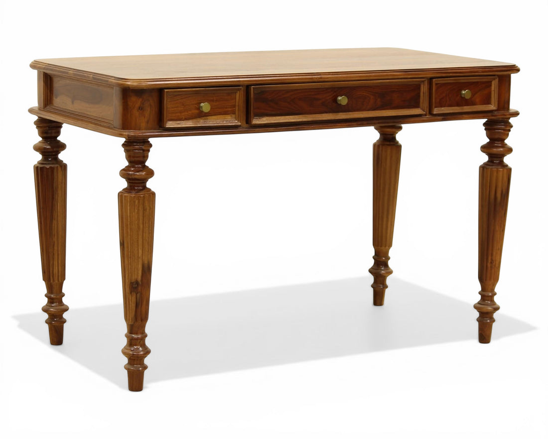 Nakoda Homes dark wood writing desk with three drawers and carved legs. Ideal for home office or living space.
