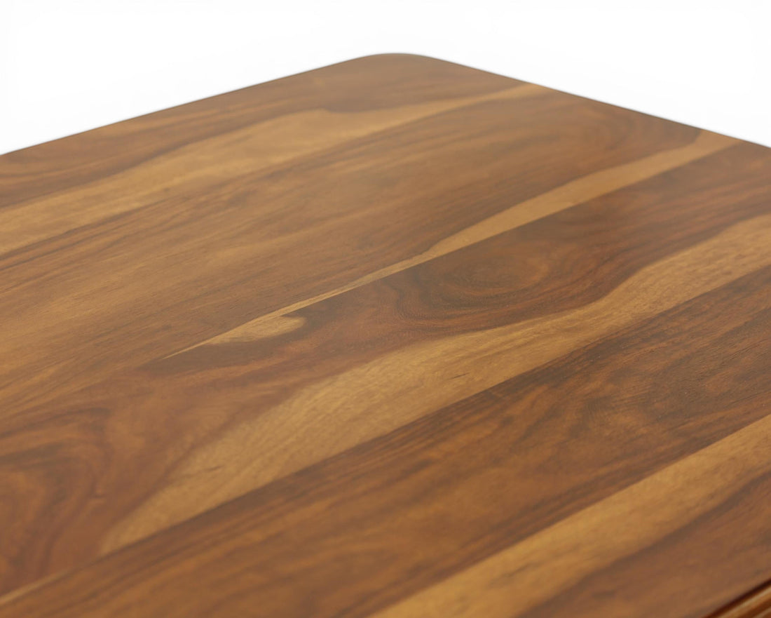 Nakoda Homes dark wood writing desk with carved legs and brass knobs. Spacious surface, three drawers.
