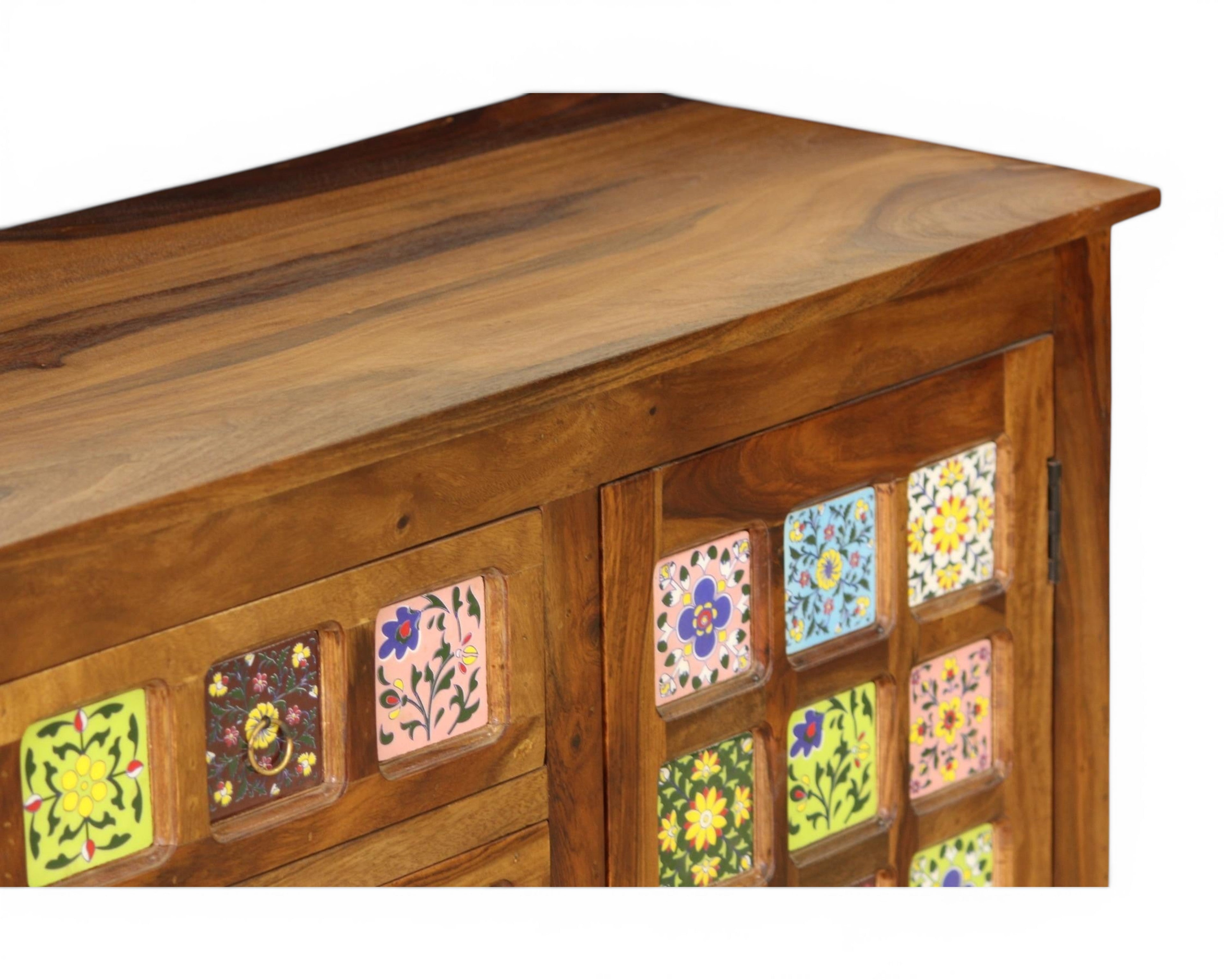 Nakoda Homes wooden cabinet with colorful hand-painted floral ceramic tile accents and brass drawer pull.