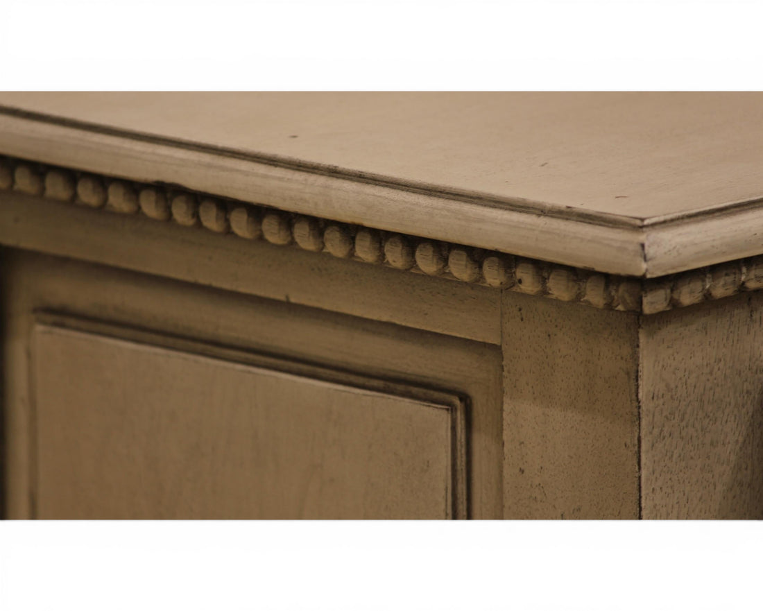 Nakoda Homes distressed grey wood two-drawer accent table with beaded trim and brass knobs.