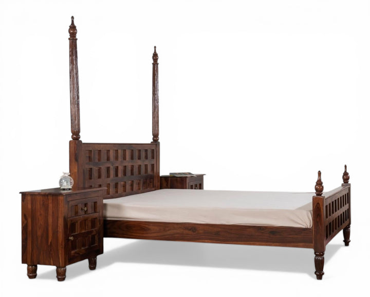 Nakoda Homes dark wood four poster bed frame with carved geometric headboard and turned legs.