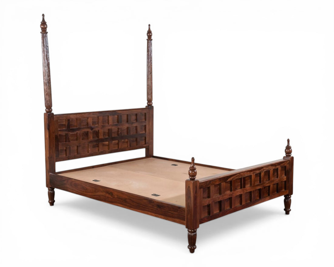 Nakoda Homes four poster bed frame in dark wood with geometric carved headboard and footboard, turned legs, and finials.