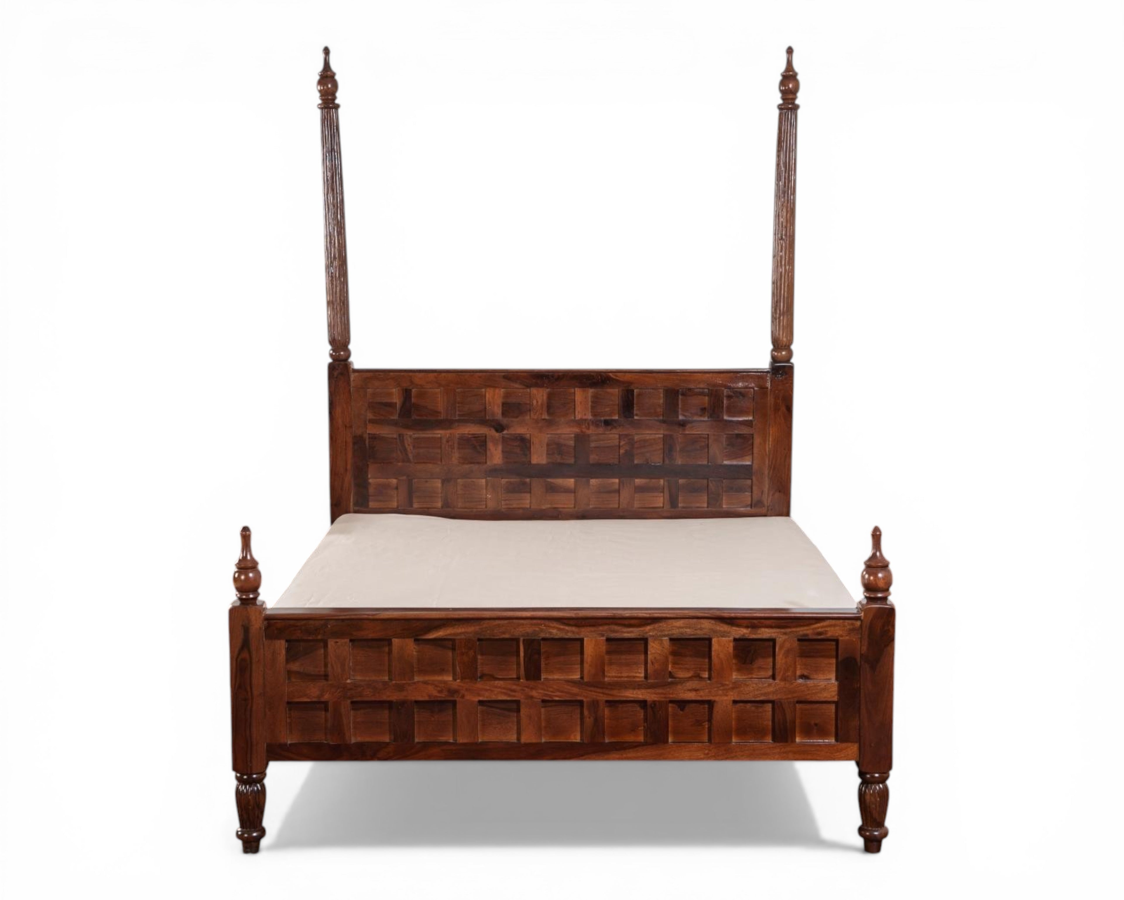 Nakoda Homes solid wood four poster bed frame with geometric carved headboard and footboard, turned legs, and finials.