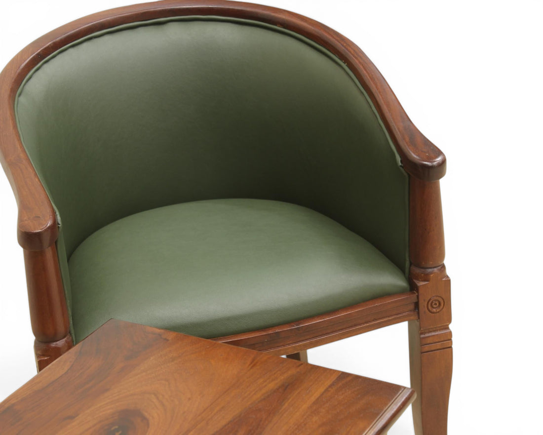 Nakoda Homes forest green faux leather barrel-back accent chair with dark wood frame and turned legs.