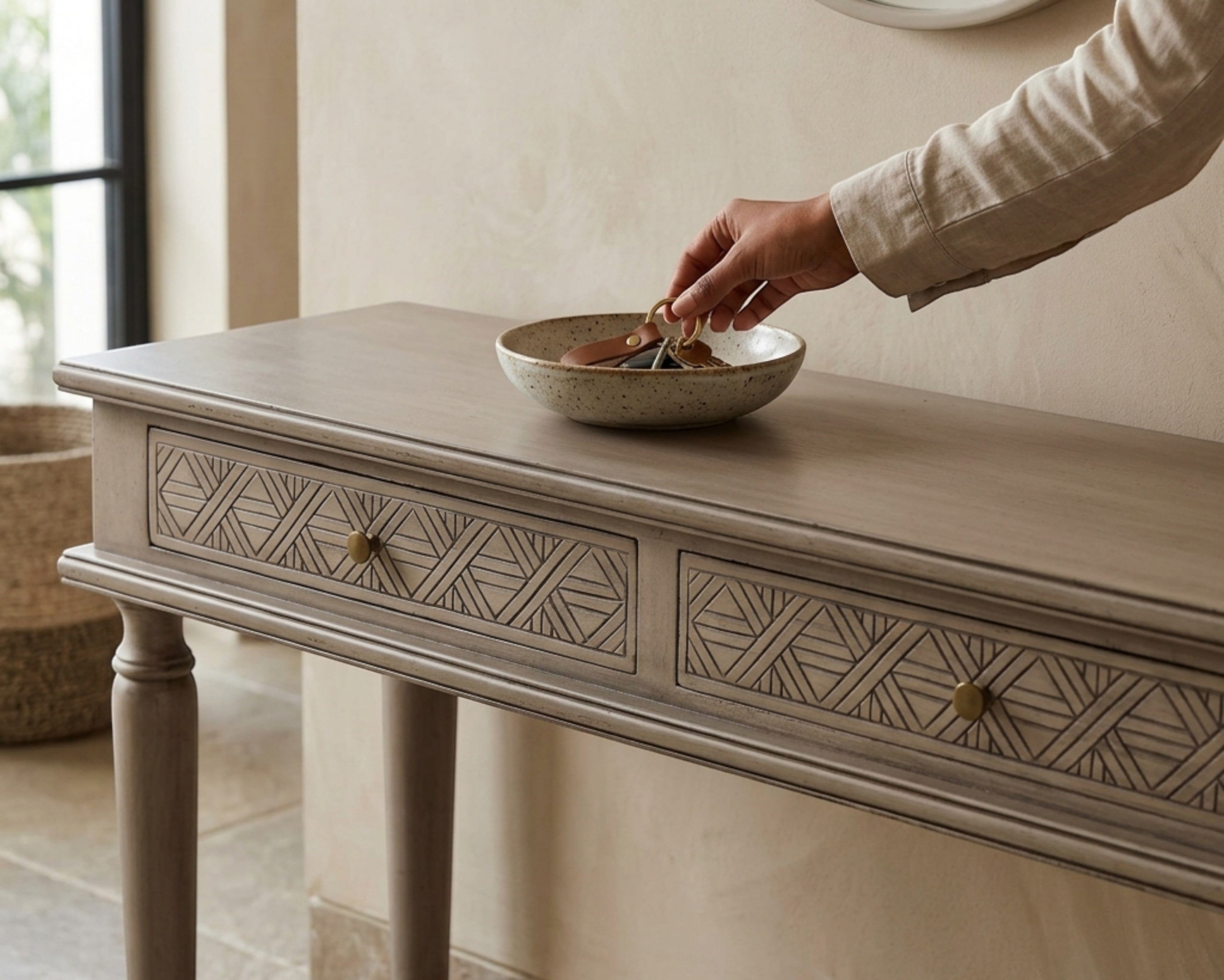 Nakoda Homes distressed grey wood console table with two carved drawers and brass knobs, turned legs.