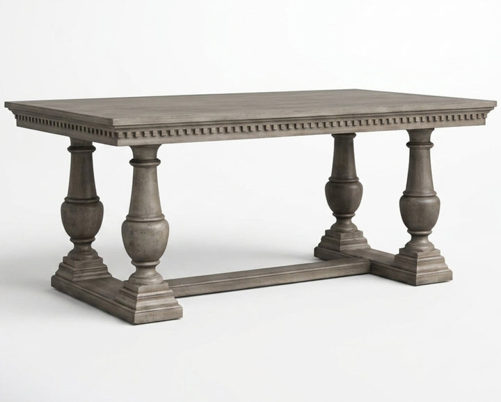 Nakoda Homes ornate grey wood dining table with carved edge and pedestal legs. Rectangular top, classic elegance.
