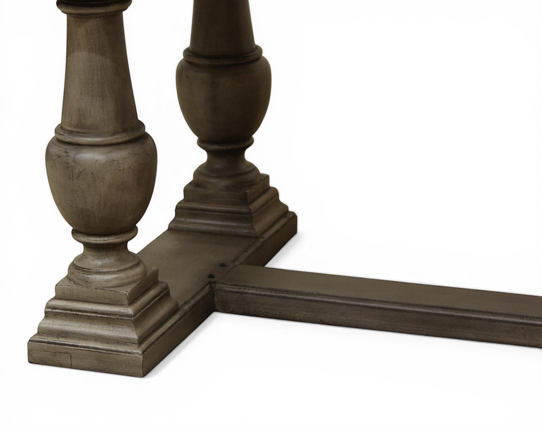 Nakoda Homes ornate grey wood pedestal dining table with carved edge and rectangular top.