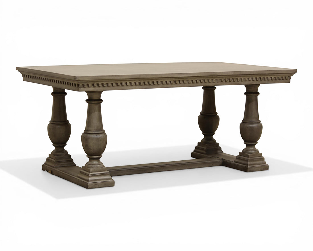 Nakoda Homes grey wood ornate pedestal dining table with carved edge and rectangular top.