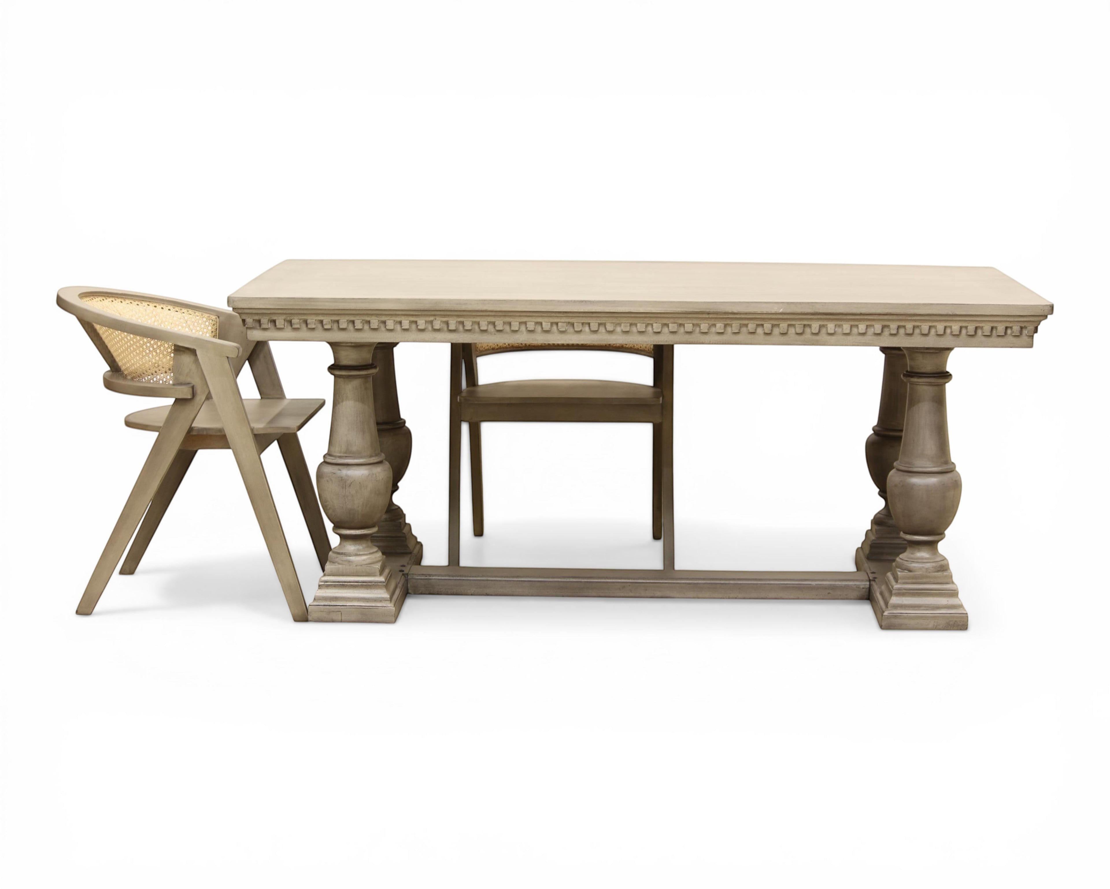 Nakoda Homes ornate grey wood dining table with carved edge and pedestal legs. Rectangular top, classic elegance.