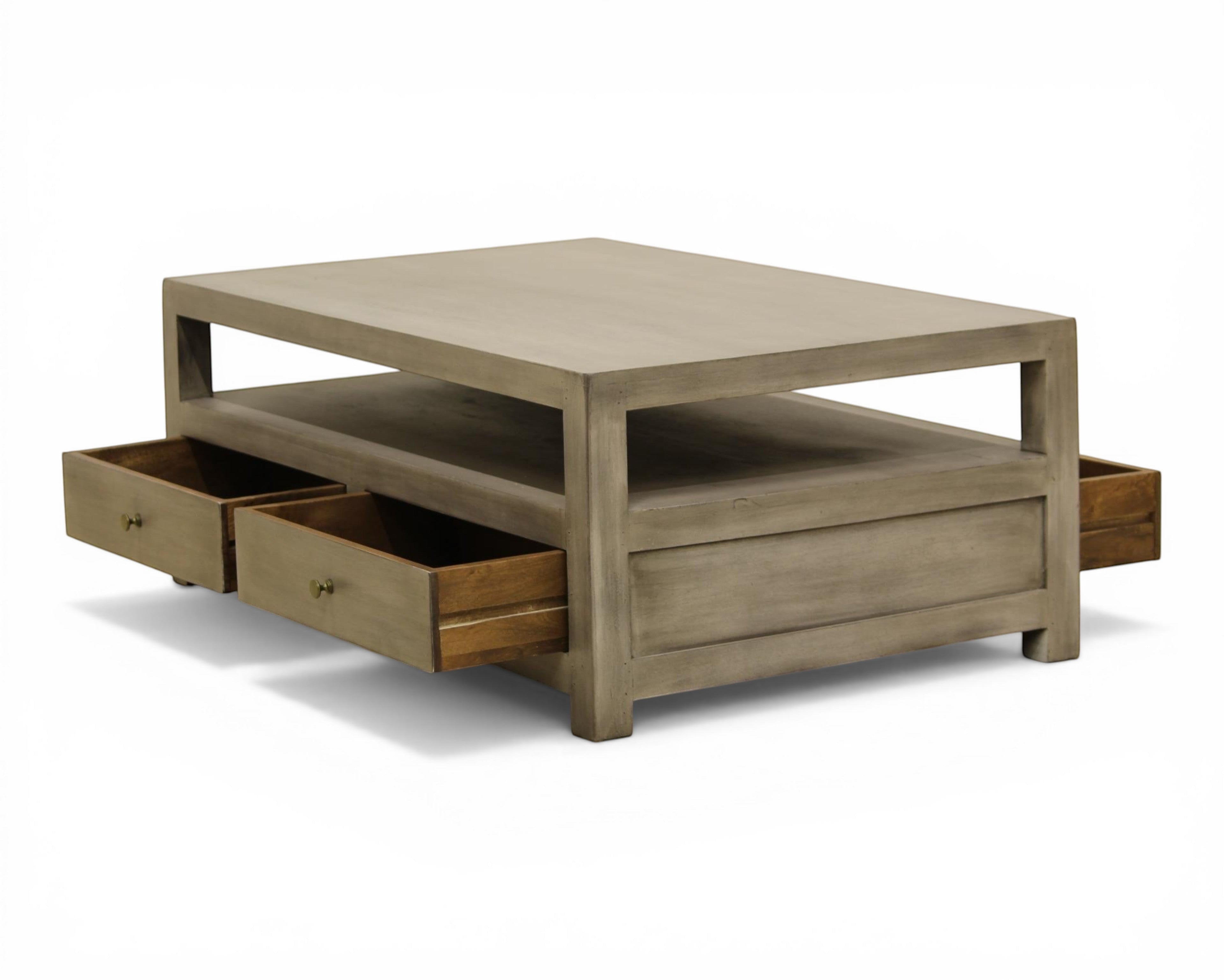 Nakoda Homes grey wash wood coffee table with open shelf and two brass knob drawers for storage.