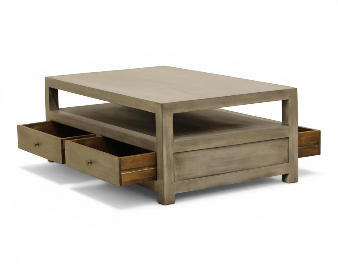 Nakoda Homes grey wash wood coffee table with open shelf and two brass knob drawers for storage.