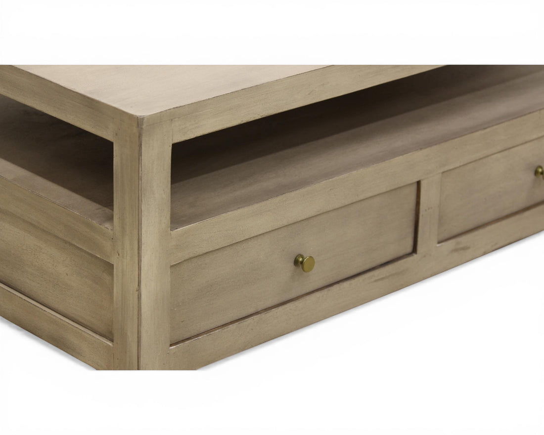 Nakoda Homes grey wash wood coffee table with open shelf and two brass knob drawers for storage.