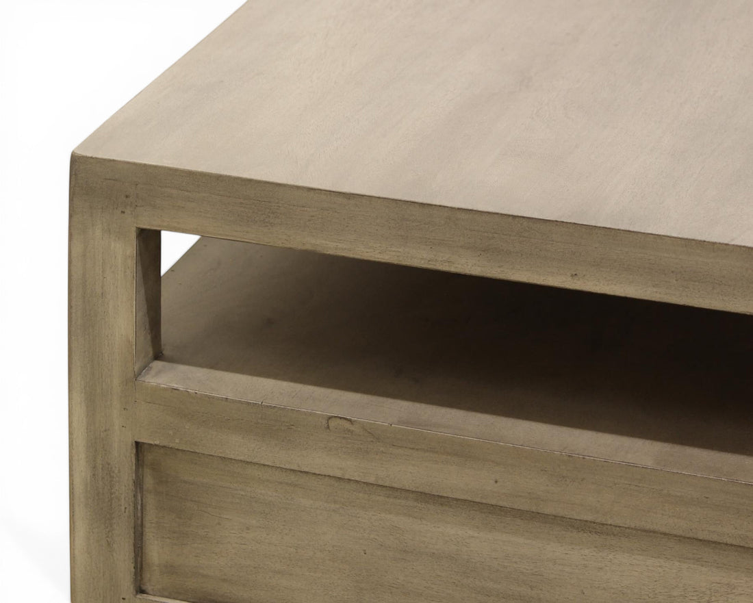 Nakoda Homes modern grey wash wood coffee table with open shelf and two drawers.