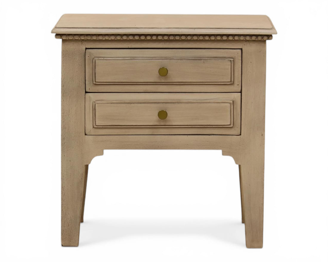 Nakoda Homes distressed grey wood two-drawer accent table with brass knobs and beaded trim.