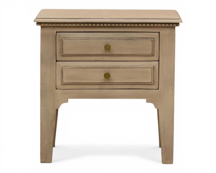 Nakoda Homes distressed grey wood two-drawer accent table with brass knobs and beaded trim.