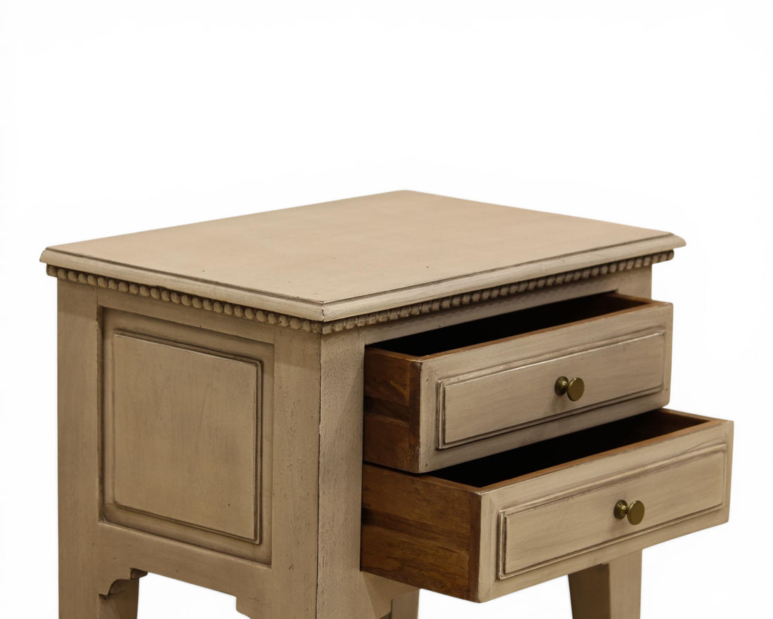 Nakoda Homes distressed grey wood two-drawer accent table with brass knobs and beaded trim.