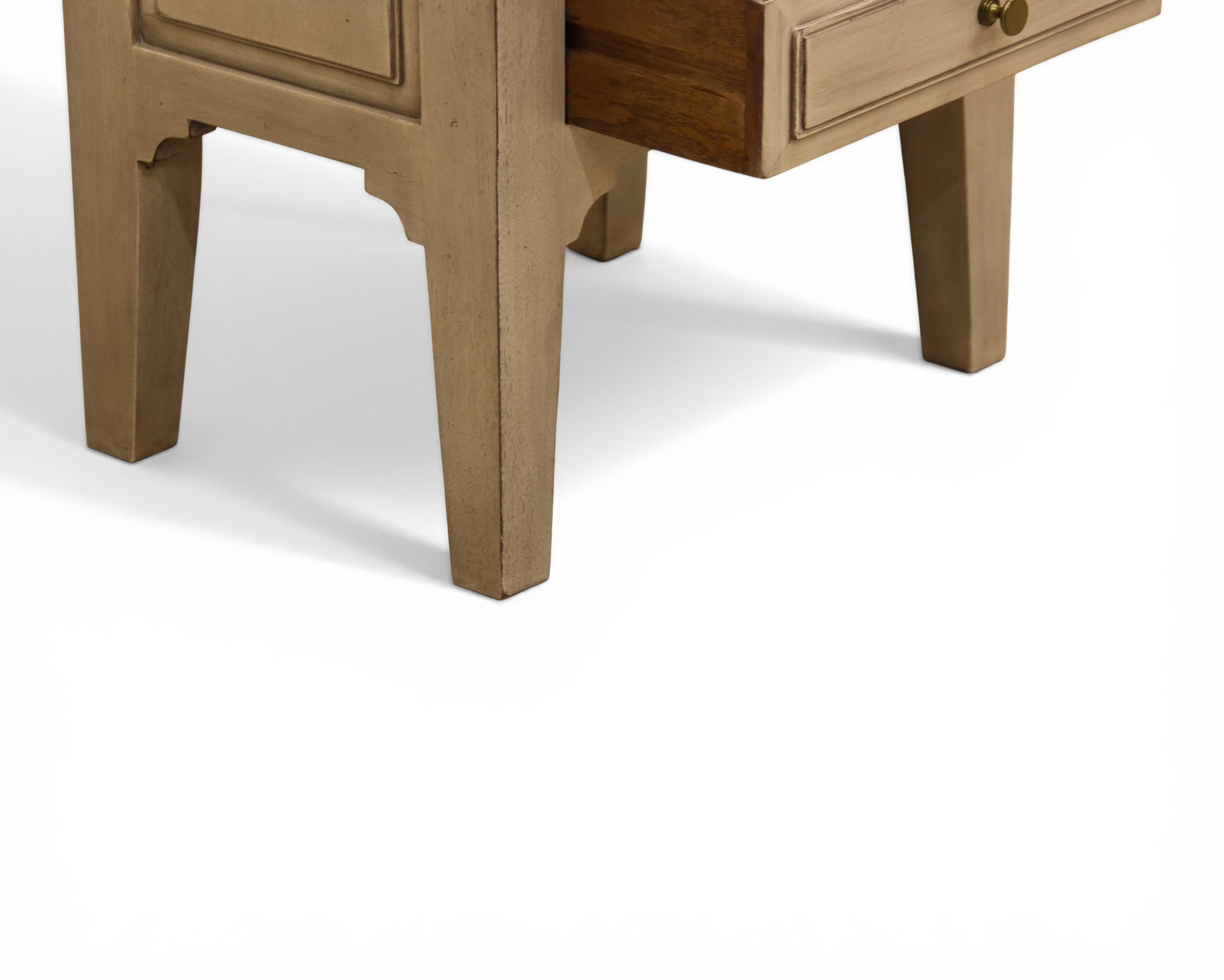 Nakoda Homes distressed grey wood two-drawer accent table with brass knobs and beaded trim.