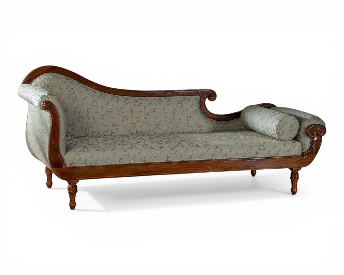 Nakoda Homes elegant light blue floral fabric chaise lounge sofa with wooden frame and ornate detailing.
