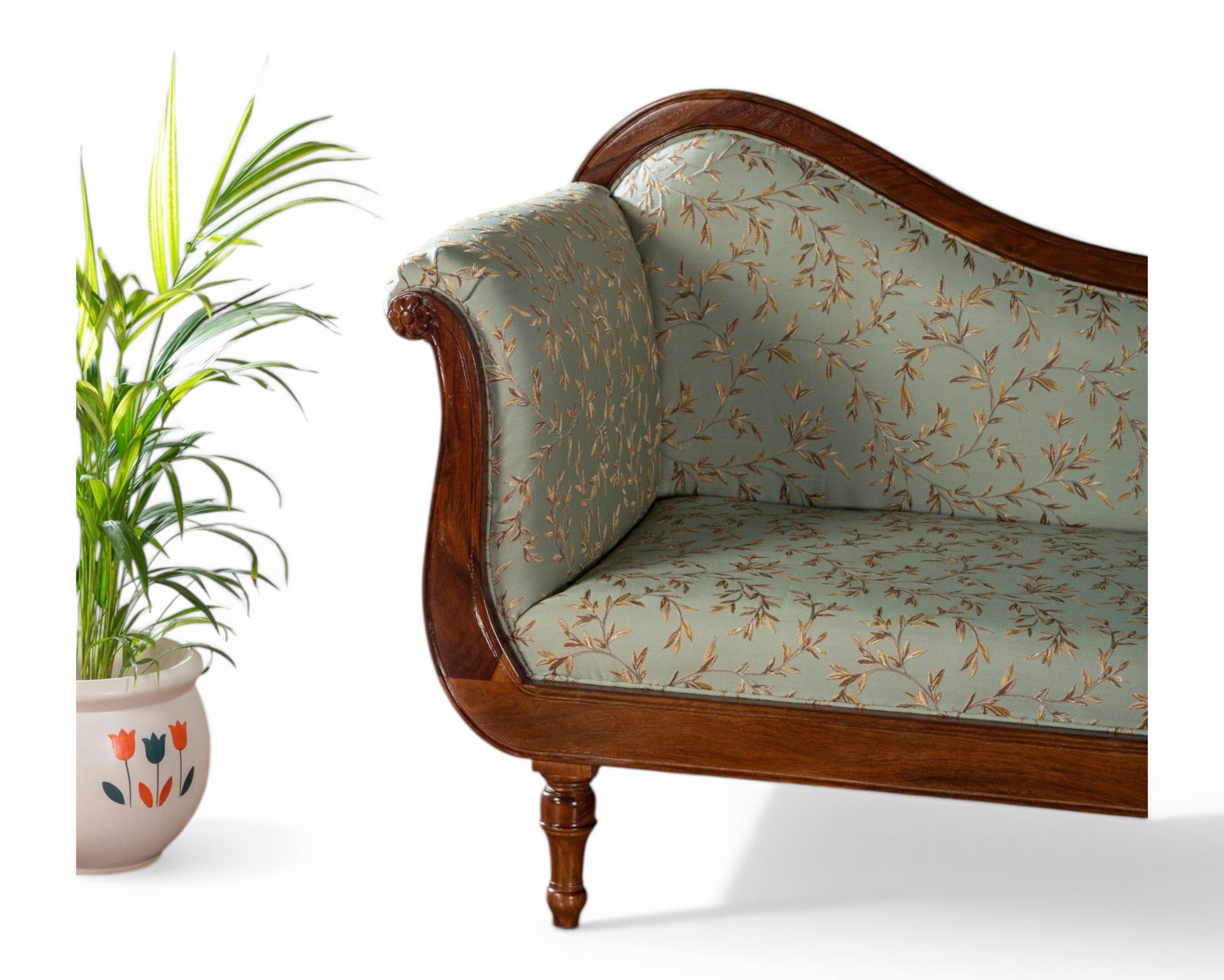 Nakoda Homes light blue floral fabric chaise lounge with wooden frame and ornate detailing.