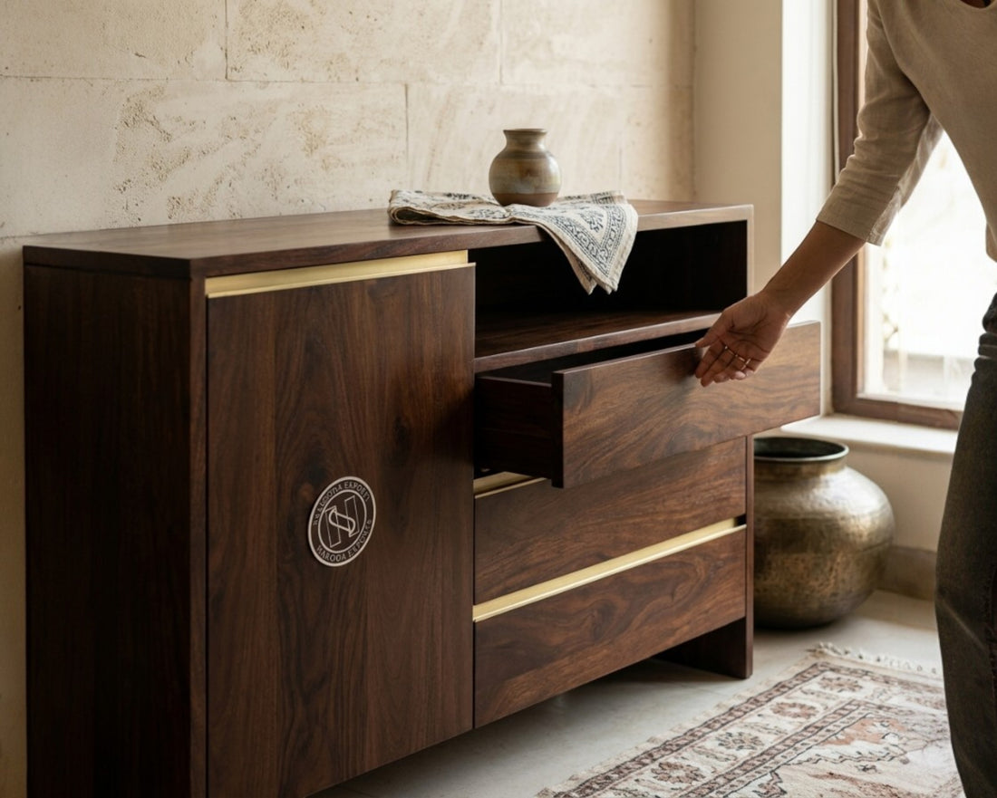 Nakoda Homes Maglory chest of drawers in dark wood finish with brass accents and open shelving.