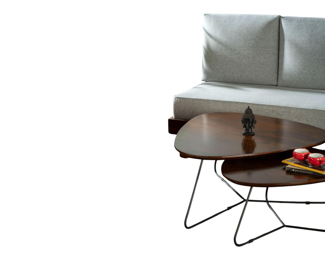 Nakoda Homes modern light grey upholstered sofa with a rich-toned wooden frame, paired with a nesting coffee table.