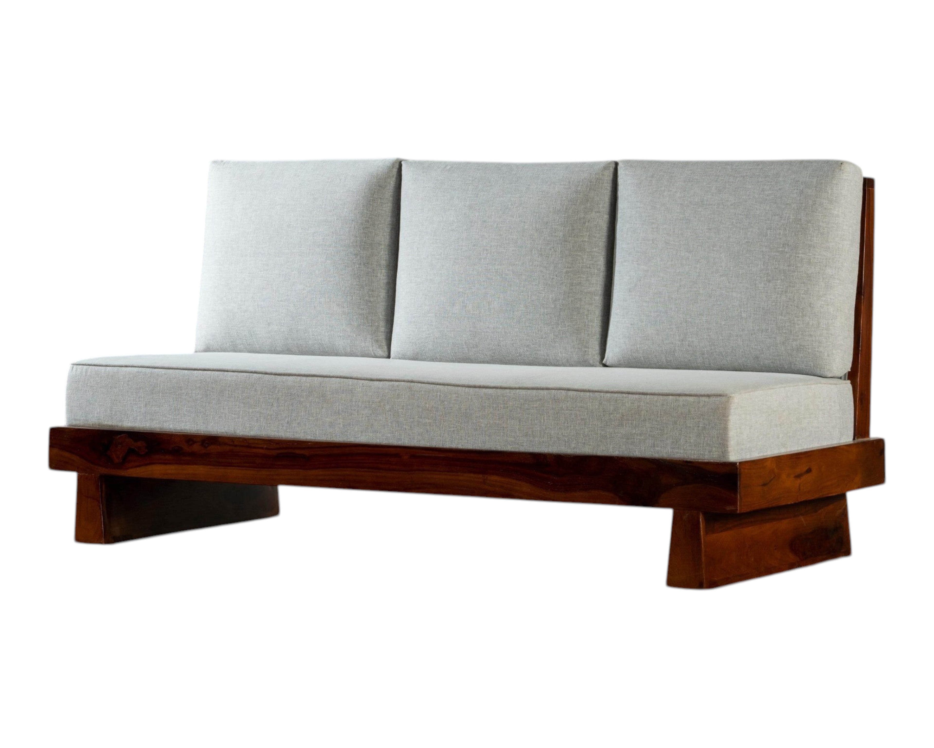 Nakoda Homes modern three-seater sofa with light grey upholstered cushions and a rich-toned wooden frame. Minimalist design.
