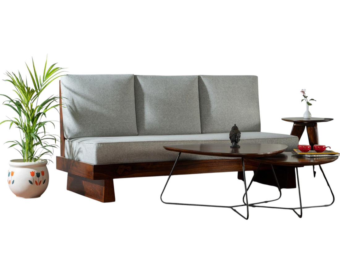 Nakoda Homes modern three-seater sofa with light grey upholstered cushions and a rich-toned wooden frame.