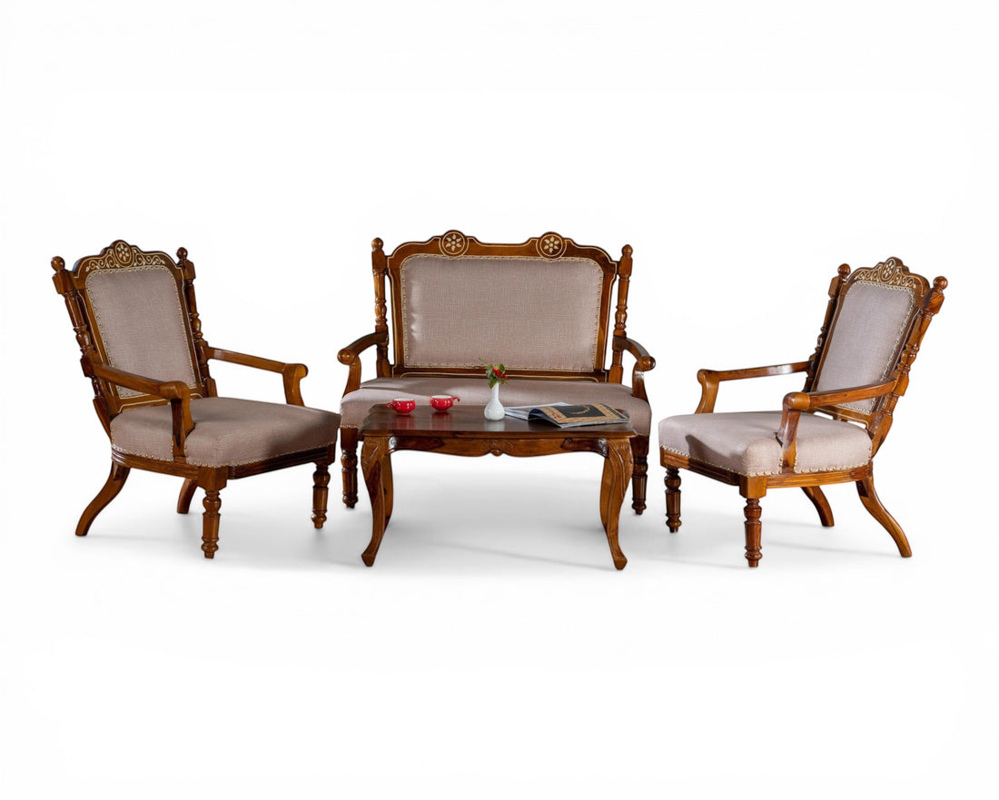 Nakoda Homes ornate carved wood armchair with neutral upholstered seat and back, nailhead trim, and curved legs.